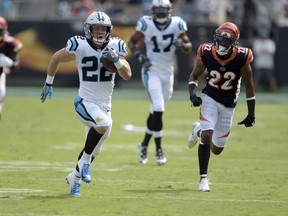 Carolina Panthers' Christian McCaffrey, left, runs past Cincinnati Bengals' William Jackson, right, during the first half of an NFL football game in Charlotte, N.C., Sunday, Sept. 23, 2018.