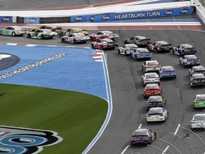 Austin Cindric (22) leads the field into Turn 1 at the start of the NASCAR Xfinity series auto race at Charlotte Motor Speedway in Concord, N.C., Saturday, Sept. 29, 2018.