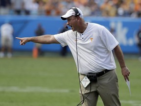 Tennessee head coach Jeremy Pruitt directs his team against West Virginia in the first half of an NCAA college football game in Charlotte, N.C., Saturday, Sept. 1, 2018.