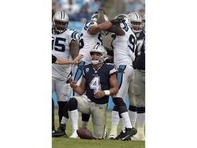 Carolina Panthers' Wes Horton (96) and Mario Addison (97) celebrate a sack of Dallas Cowboys' Dak Prescott (4) during the second half of an NFL football game in Charlotte, N.C., Sunday, Sept. 9, 2018.