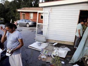 Seema Depani, left, helps her family clean up after flooding from Hurricane Florence destroyed the Starlite Motel which her family owns in Spring Lake, N.C., Wednesday, Sept. 19, 2018.