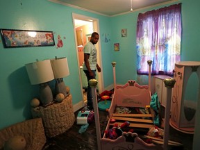Afghanistan war veteran, Jose Perez-Santiago, stands in his daughter's home as he returns for the first time since it was flooded in the aftermath of Hurricane Florence in Spring Lake, N.C., Wednesday, Sept. 19, 2018. "I didn't realize we would lose everything," said Perez-Santiago. "We'll just have to start from the bottom again."