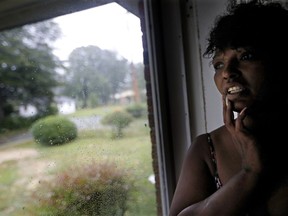 Nichole Worley looks out from her home in Lumberton, N.C., Friday, Sept. 14, 2018, as rains from Hurricane Florence threaten the neighborhood with flooding. Two years ago, Worley's house, and most of the houses around her, took in water up to its eaves during Hurricane Matthew. "I don't think we can stand another one," she says. "I can't do this again."