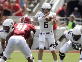 James Madison quarterback Ben DiNucci (6) takes a snap during the first half an NCAA college football game against North Carolina State in Raleigh, N.C., Saturday, Sept. 1, 2018.
