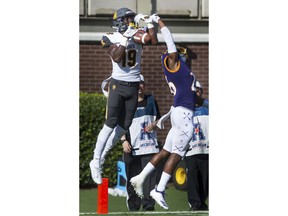 North Carolina A&T's Zachary Leslie, left, makes the catch for a touchdown while being defended by East Carolina's Colby Gore during an NCAA college football game Sunday, Sept. 2, 2018, in Greenville, N.C.