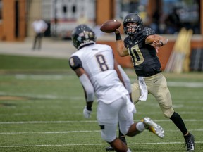 Wake Forest quarterback Sam Hartman, right, throws a touchdown pass against Towson defensive back Monty Fenner in the first half of a NCAA college football game in Winston-Salem, N.C., Saturday, Sept. 8, 2018.