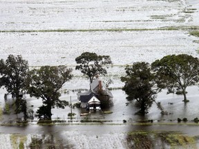 A farm house is surrounded by flooded fields from tropical storm Florence in Hyde County, N.C., Saturday, Sept. 15, 2018.