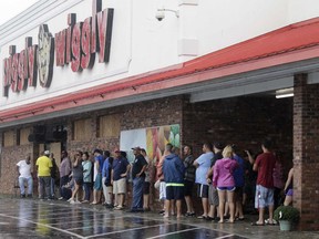 People wait for the Piggly Wiggly grocery store to open after Hurricane Florence hit Richlands N.C.,Sunday, Sept. 16, 2018.