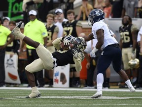 Wake Forest's Greg Dortch (3) is pulled down from behind by Rice's Jorian Clark (9) during the first half of their NCAA college football game, Saturday, Sept. 29, 2018, in Winston-Salem, N.C.
