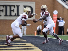 Boston College running back AJ Dillon (2) takes a handoff from quarterback Anthony Brown (13) during the first half of an NCAA college football game against Wake Forest, Thursday, Sept. 13, 2018, in Winston-Salem, N.C.