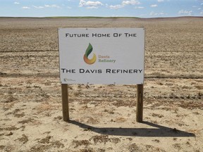 FILE - This July 19, 2018, file photo, shows a sign on property near southwest Belfield, N.D, for the proposedfuture home of the Davis Refinery near Theodore Roosevelt National Park. North Dakota regulators are enlisting an administrative law judge to help untangle some of the legal questions surrounding whether an oil refinery can be built near the park. Meridian Energy Group plans to build the refinery 3 miles from the park. Two environmental groups maintain that Meridian needs state approval for the site. Meridian disputes that.