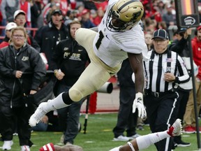 Purdue running back D.J. Knox (1) leaps over Nebraska defensive back Lamar Jackson (21), during the first half of an NCAA college football game in Lincoln, Neb., Saturday, Sept. 29, 2018.