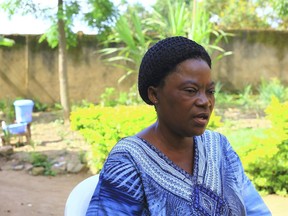 In this photo taken Sunday Aug. 26, 2018, Leoni Kahumbu, mother of Pascaline, a 15-year-old who was infected with Ebola and survived speaks to journalists, in Beni, Democratic Republic of Congo. Pascaline was among the first people given mAb114, one of five experimental treatments approved for use in Congo's latest Ebola outbreak. Now she and other survivors must now deal with the emotional toll of returning to nervous communities where they could be shunned.