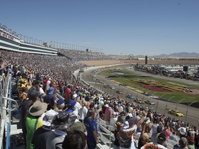 Fans stand for the beginning of a NASCAR Cup Series auto race Sunday, Sept. 16, 2018, in Las Vegas.
