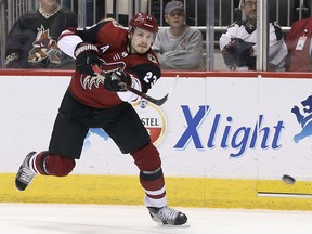 FILE - In this Dec. 2, 2017, file photo, Arizona Coyotes' Oliver Ekman-Larsson shoots the puck against the New Jersey Devils during the second period of an NHL hockey game, in Glendale, Ariz.