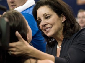 FILE - In this April 23, 2010, file photo, UCLA gymnastics coach Valorie Kondos Field, right, congratulates a member of her team after they won the NCAA gymnastics championships, in Gainesville, Fla. Longtime UCLA women's gymnastics coach Valorie Kondos Field's 29th season leading the Bruins will be her last.  Kondos Field says she is retiring next spring to explore other pursuits, ending a remarkable run in which she's led UCLA to seven national titles.