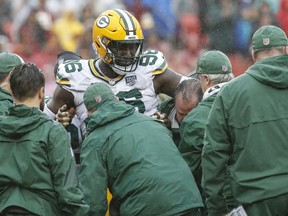 FILE - In this Sunday, Sept. 23, 2018, file photo, Green Bay Packers defensive end Muhammad Wilkerson (96) is picked up after an injury during the first half of an NFL football game against the Washington Redskins, in Landover, Md. Wilkerson underwent surgery on his left ankle after the Packers' loss at Washington on Sunday and will be lost for the season. The surgery was performed in the Washington area and Packers coach Mike McCarthy said Monday, Sept. 24 that Wilkerson's injury was "significant."
