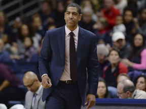 FILE - In this Feb. 25, 2018, file photo, then-Connecticut coach Kevin Ollie watches during the first half the team's NCAA college basketball game in Storrs, Conn. The University of Connecticut and former coach Ollie have been notified by the NCAA of alleged recruiting and other violations during his tenure at the school. The notice of allegations, released Friday night, Sept. 28, by UConn with the names of recruits redacted, includes numerous charges, including unethical conduct by Ollie for allegedly provided false or misleading information about video calls to a recruit from two former UConn stars, Hall of Famer Ray Allen and San Antonio Spurs guard Rudy Gay.
