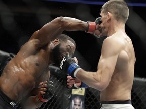 FILE - In this March 4, 2017, file photo, Tyron Woodley, left, hits Stephen Thompson in a welterweight championship mixed martial arts bout at UFC 209, in Las Vegas. Woodley is back to defend his welterweight championship for the first time since UFC President Dana White blasted a winning performance last summer, when Woodley said he injured a shoulder during the fight. Since that event in California about 13 months ago, Woodley had surgery and dismissed an event for an interim welterweight title as a bout for a "boo-boo belt." The 36-year-old didn't seem as interested in taking on the sanctioning body as he prepared to face undefeated challenger Darren Till at UFC 228 on Saturday night.