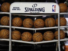FILE - In this Dec. 6, 2017, file photo, basketballs sit in a rack on the court during a training session by the Brooklyn Nets at the Mexico City Arena in Mexico City. The four major pro sports leagues and the NCAA think that expanding legal betting  will lead to more game-fixing. The architects of New Jersey's successful legal challenge to the sports gambling ban say those fears are overstated and that bringing sports betting out of the shadows will make it easier to detect illegal activity.
