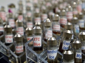 FILE - This Dec. 4, 2013 file photo shows vials of flavored liquid at a store selling electronic cigarettes and related items in Los Angeles. On Wednesday, Sept. 12, 2018, U.S. health officials said teenage use of e-cigarette has reached "epidemic" levels in the U.S. and are calling on the industry to address the problem or risk having their flavored products pulled off the market.