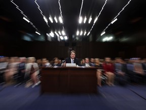 FILE - In this Thursday, Sept. 6, 2018 file photo made with a slow shutter speed and a zoom lens, President Donald Trump's Supreme Court nominee, Brett Kavanaugh testifies before the Senate Judiciary Committee on Capitol Hill in Washington, for the third day of his confirmation hearing. On Thursday, Sept. 20, 2018, an attorney for Christine Blasey Ford said she would testify to the Senate next week about her accusation that Kavanaugh assaulted her when both were high school students if agreement can be reached to "terms that are fair and which ensure her safety."