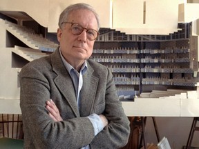 FILE - In this April 1991 file photo, architect Robert Venturi poses in his office in the Manayunk section of Philadelphia, with a model of a new hall for the Philadelphia Orchestra in background. Venturi, who turned austere modern design on its ear, ushering in postmodern complexity with the dictum "Less is a bore," has died. He was 93. His family released a statement on his firm's website saying Venturi died at home in Philadelphia on Tuesday, Sept. 18, 2018, after a brief illness, and was surrounded by his wife and son.