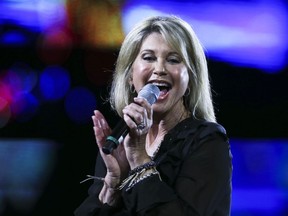 FILE - In this Feb. 23, 2017, file photo, Olivia Newton-John performs during the Viña del Mar International Song Festival at the Quinta Vergara in Viña del Mar, Chile. Newton-John said she has been diagnosed with cancer for the third time in three decades. The four-time Grammy winner, who will turn 70 on Sept. 26, told Australian news program "Sunday Night" doctors found a tumor in her lower back in 2017.