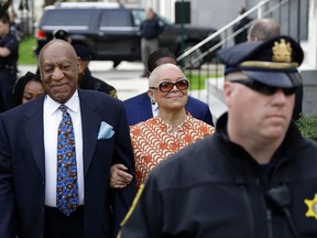 FILE - In this April 24, 2018, file photo, Bill Cosby, left, arrives with his wife, Camille, for his sexual assault trial, at the Montgomery County Courthouse in Norristown, Pa. Cosby's wife wants a Pennsylvania ethics board to investigate the judge set to sentence her husband Sept. 24, on felony sex assault charges.
