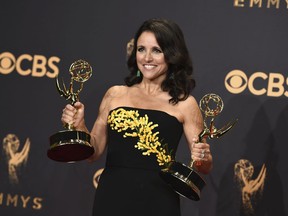 FILE - In this Sunday, Sept. 17, 2017 file photo, Julia Louis-Dreyfus poses in the press room with her awards for outstanding lead actress in a comedy series and outstanding comedy series for "Veep" at the 69th Primetime Emmy Awards at the Microsoft Theater in Los Angeles. Louis-Dreyfus is back at work on "Veep" and says it feels "fantastic." The star of the HBO comedy series revealed last September that she had been diagnosed with breast cancer. The news came soon after her sixth consecutive Emmy win for the role of Selina Meyer.