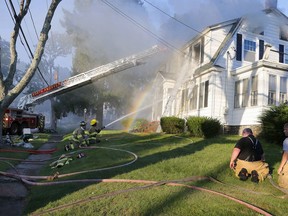 FILE - In this Sept. 13, 2018, file photo, firefighters battle a house fire on Herrick Road in North Andover, Mass., one of multiple emergency crews responding to a series of gas explosions and fires triggered by a problem with a gas line that feeds homes in several communities north of Boston. The pressure in natural gas pipelines prior to a series of explosions and fires in Massachusetts last week was 12 times higher than it should have been. The information was in a letter from the state's U.S. senators to the heads of Columbia Gas and NiSource.