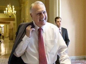 FILE - In this Dec. 30, 2012, file photo, Senate Minority Whip Jon Kyl, R-Ariz., walks between the Senate chamber and the office of Senate Minority Leader Mitch McConnell, R-Ky., in Washington. Sen. John McCain's widow on Tuesday, Sept. 4, 2018, said Kyl will fill her late husband's seat.