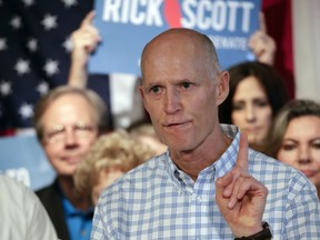 FILE - In this Sept. 6, 2018, file photo, Florida Gov. Rick Scott speaks to supporters at Republican rally in Orlando, Fla. Top Florida Republicans including Scott have been quick to say President Donald Trump is wrong about the death toll in Puerto Rico. Scott said he disagreed with the president and that he has seen the "devastation firsthand."