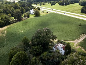 This Sept. 7, 2018, photo shows a farmhouse is surrounded by soybean fields in Locust Hill, Va. The U.S. and China have imposed import taxes on $50 billion worth of each other's products. Caught in the crossfire are U.S. soybean farmers, a prime target of Beijing's retaliatory tariffs, whose exports to China account for about 60 percent of their overseas sales.