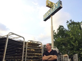 In this Sept. 2, 2017 photo, Bobby Jucker, owner of Three Brothers Bakery, cleans up storm damage at his bakery in Houston. Retailers struggle in Houston a year after Hurricane Harvey flooded the city. Janice and Bobby Jucker continue to rebuild the business at Three Brothers Bakery. They have three stores, one of which was flooded; and Janice says sales are down 25 percent from before the storm.