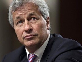 FILE- In this June 13, 2012, file photo, JPMorgan Chase CEO Jamie Dimon testifies before the Senate Banking Committee on Capitol Hill in Washington. Dimon, is saying he would be able to beat President Donald Trump in an election, but also says he isn't running for the nation's top office. The nation's most powerful banker told reporters at an event at JPMorgan headquarters Wednesday, Sept. 12, 2018, that "I think I could beat Trump."