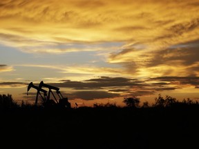 FILE- In this June 5, 2017, file photo pumpjacks work in an oil field at sunset after a thunderstorm passed through the area in Karnes City, Texas. The United States may have reclaimed the title of the world's biggest oil producer sooner than expected. The U.S. Energy Information Administration said Wednesday that America "likely surpassed" Russia in June and August after jumping over Saudi Arabia earlier this year.