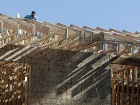 FILE- In this Thursday, Aug. 30, 2018, file photo, a worker toils on a new home under construction in Denver. On Wednesday, Sept. 19, the Commerce Department reports on U.S. home construction in August.