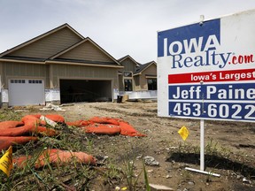 FILE- In this June 27, 2018, file photo, a for sale sign is seen in front of a home for sale in Waukee, Iowa. On Thursday, Sept. 26, The Commerce Department reports on sales of new homes in August.