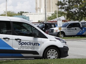 This Tuesday, Sept. 4, 2018, photo shows Charter Communications, Inc.'s Spectrum trucks in the parking lot at a Spectrum customer center in Orlando, Fla. Cable company Charter is launching a $45-a-month unlimited-data phone plan as cable companies try to diversify to offset slowing traditional cable TV revenue.