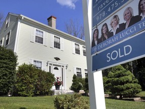 FILE- In this July 31, 2018, file photo, a sign shows a house sold in North Andover, Mass. On Thursday, Sept. 20, the National Association of Realtors reports on sales of existing homes in August.