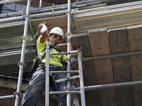 In this June 20, 2018 photo, a worker wields a hammer at a construction site in Boston. On Wednesday, Aug. 5, the Labor Department issues revised data on productivity in the second quarter.
