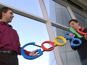 FILE- In this Jan. 15, 2004, file photo Google co-founders Larry Page, left, and Sergey Brin pose for a photo at their company's headquarters in Mountain View, Calif. Twenty years after Page and Brin set out to organize all of the internet's information, the search engine they named Google has morphed into a dominating force in smartphones, online video, email, maps and much more.