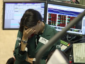 FILE - This Sept. 15, 2008, file photo shows Elizabeth Rose, a specialist with Lehman Brothers MarketMakers, working her post on the trading floor of the New York Stock Exchange. Home prices had sunk, and foreclosure notices began arriving. Layoffs began to spike. Tremors intensified as Lehman Brothers, a titan of Wall Street, slid into bankruptcy on Sept. 15, 2008. The financial crisis touched off the worst recession since the 1930s Great Depression.