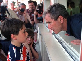 FILE- In this July 4, 1999, file photo Republican presidential hopeful George W. Bush leans out the window of Madden's Food and Ice Cream Stand to take the order of an unidentified customer in Merrimack, N.H. The former oil executive and part owner of baseball's Texas Rangers, Bush could be considered the first modern businessman-president. Bush, a Republican, defeated Al Gore in 2000 and won re-election in 2004.