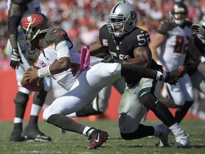 FILE - In this Oct. 30, 2016, file photo, Oakland Raiders defensive end Khalil Mack (52) sacks Tampa Bay Buccaneers quarterback Jameis Winston (3) during the second half of an NFL football game in Tampa, Fla. The Chicago Bears have acquired star pass rusher Khalil Mack from the Raiders on Saturday, Sept. 1, 2018, in a massive trade that sends two first-round draft picks to Oakland. A person with direct knowledge of the trade told The Associated Press that Oakland will get first-round selections in 2019 and 2020, a sixth-rounder next year and a third-rounder in 2020. Oakland also included its second-round selection in 2020. The person spoke on condition of anonymity because the trade had not been announced.