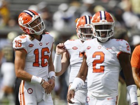 FILE - In this Saturday, Sept. 22, 2018, file photo, Clemson quarterbacks Trevor Lawrence (16) and Kelly Bryant (2) warms up before an NCAA college football game in Atlanta. Bryant is leaving the third-ranked Tigers after Lawrence was named starting quarterback this week, Clemson coach Dabo Swinney said Wednesday, Sept. 26, 2018.