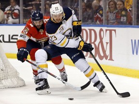 FILE - In this March 2, 2018, file photo, Buffalo Sabres center Sam Reinhart (23) battles for the puck with Florida Panthers defenseman Keith Yandle (3) during the first period of an NHL hockey game in Sunrise, Fla.  Reinhart to a two-year contract worth $7.3 million, the Sabres announced Wednesday, Sept. 19, 2018. Reinhart was a restricted free agent and missed the first five days of training camp, and two preseason games.