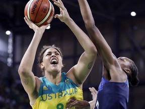 FILE - In this Aug. 9, 2016 file photo, Australia center Liz Cambage (8) shoots over France center Sandrine Gruda during the second half of a women's basketball game at the Youth Center at the 2016 Summer Olympics in Rio de Janeiro, Brazil. The 6-foot-8 Australian star came back to the WNBA this past season and dominated the competition after taking a few years away from the league.