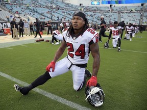 FILE - In this Aug. 25, 2018, file photo, Atlanta Falcons running back Devonta Freeman (24) stretches before an NFL preseason football game against the Jacksonville Jaguars in Jacksonville, Fla. Freeman has been ruled out for Sunday's game against Carolina because of a knee injury, coach Dan Quinn said Friday, Sept. 14, 2018.